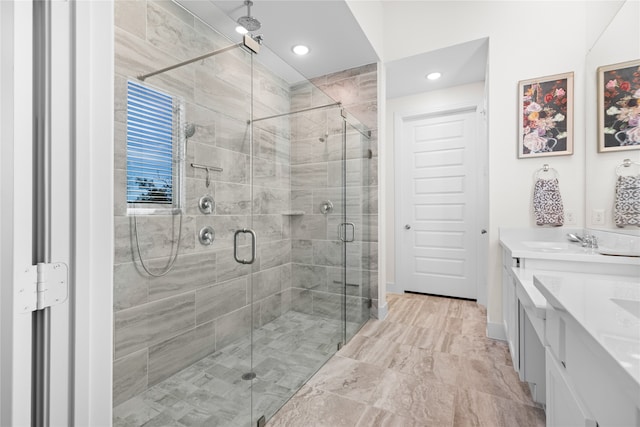 bathroom featuring vanity and a shower with shower door