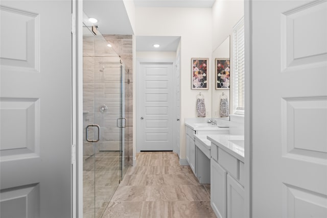 bathroom featuring vanity and a shower with door