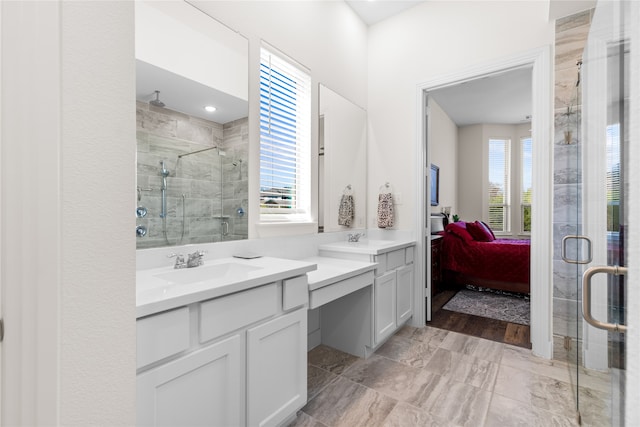 bathroom featuring vanity and a shower with shower door