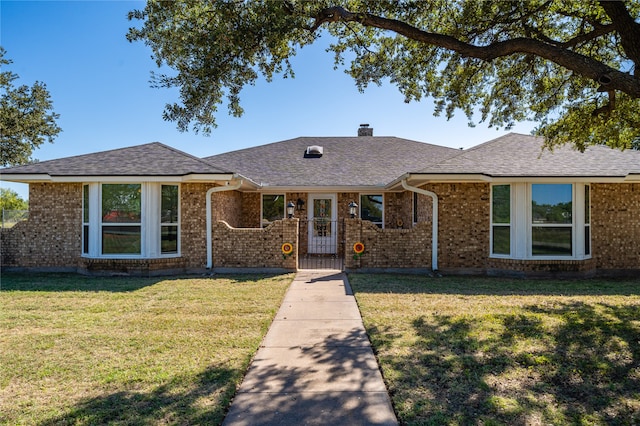 ranch-style house with a front lawn