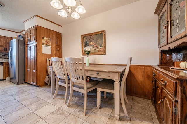 dining space featuring a chandelier, light tile patterned flooring, and a textured ceiling