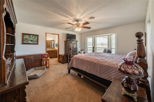 carpeted bedroom with a textured ceiling, ensuite bath, access to exterior, and ceiling fan