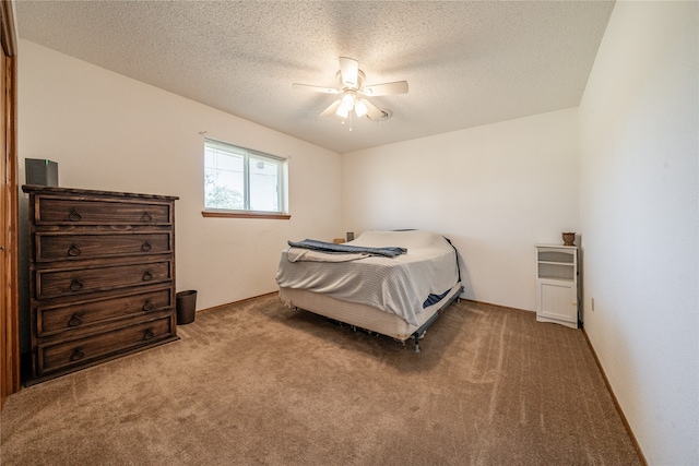 carpeted bedroom with a textured ceiling and ceiling fan