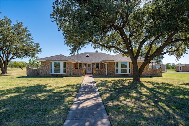 ranch-style house featuring a front lawn