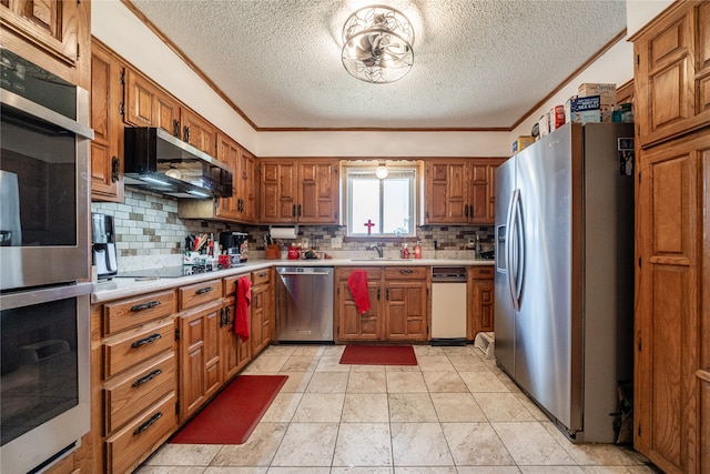 kitchen featuring decorative backsplash, light tile patterned floors, a textured ceiling, crown molding, and stainless steel appliances