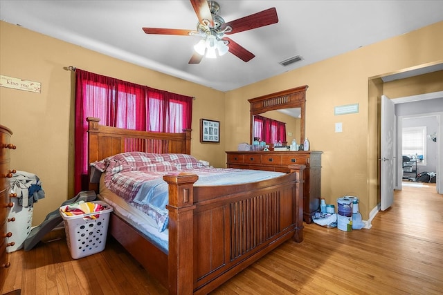 bedroom featuring light hardwood / wood-style floors and ceiling fan