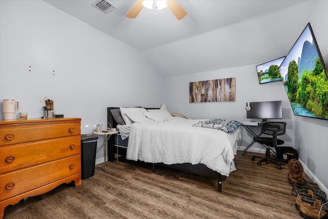 bedroom with dark hardwood / wood-style flooring, vaulted ceiling, and ceiling fan