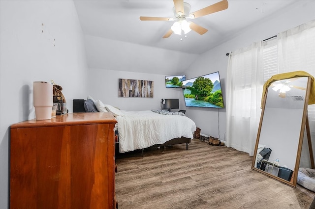 bedroom featuring lofted ceiling, hardwood / wood-style flooring, and ceiling fan