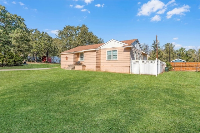 rear view of property featuring a yard