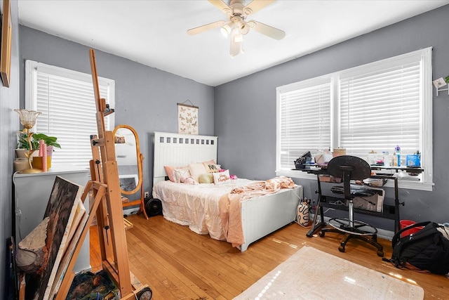 bedroom with light wood-type flooring and ceiling fan