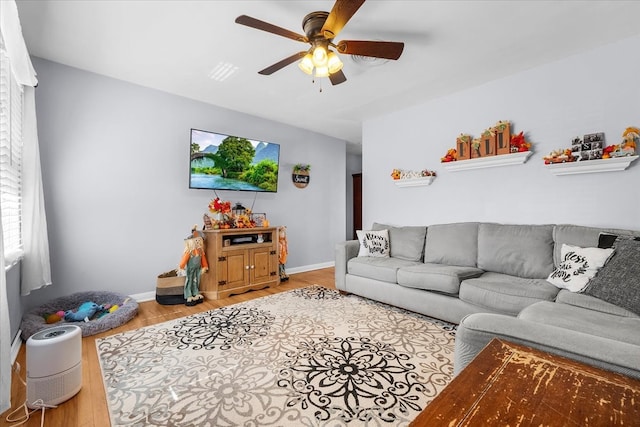 living room with ceiling fan and wood-type flooring