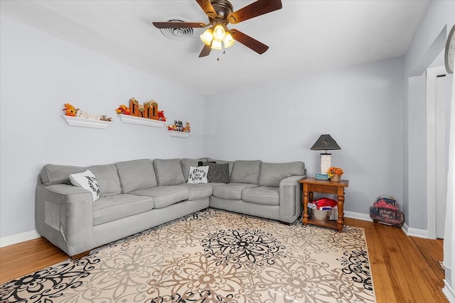 living room featuring ceiling fan and light wood-type flooring