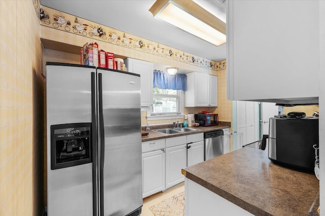 kitchen featuring white cabinetry, appliances with stainless steel finishes, and sink