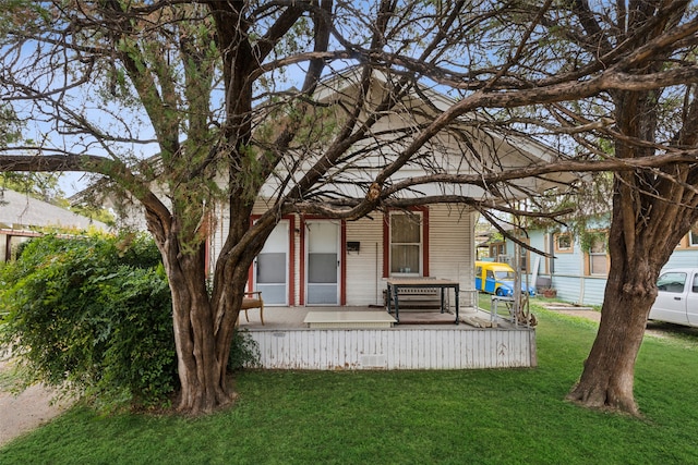 back of property featuring a lawn