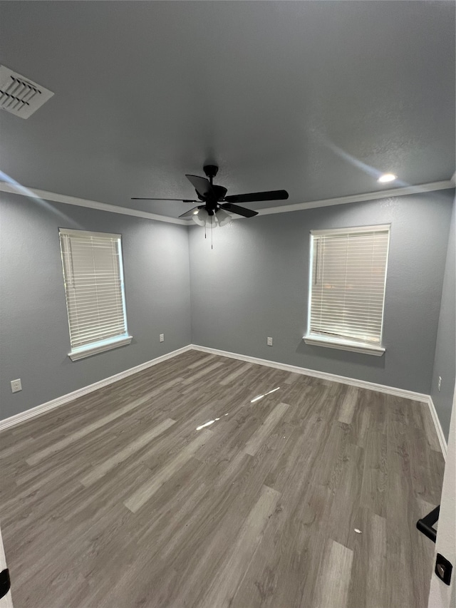 unfurnished room with crown molding, wood-type flooring, and ceiling fan