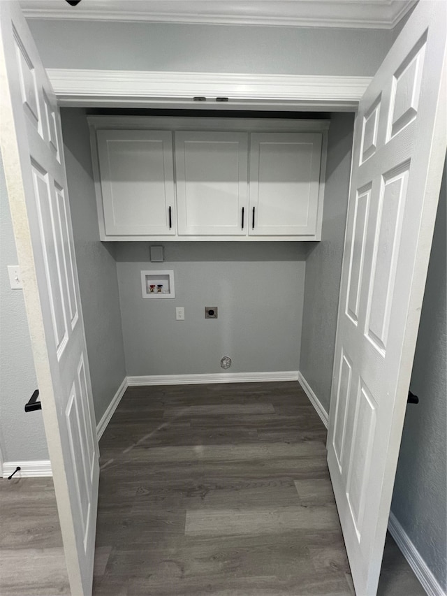 laundry area with hookup for an electric dryer, hookup for a washing machine, dark hardwood / wood-style floors, and cabinets