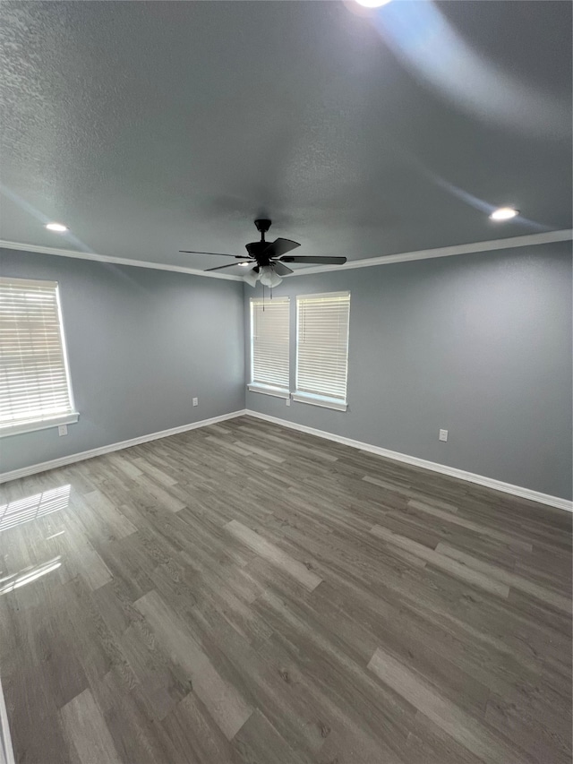 spare room featuring crown molding, ceiling fan, a textured ceiling, and dark hardwood / wood-style flooring