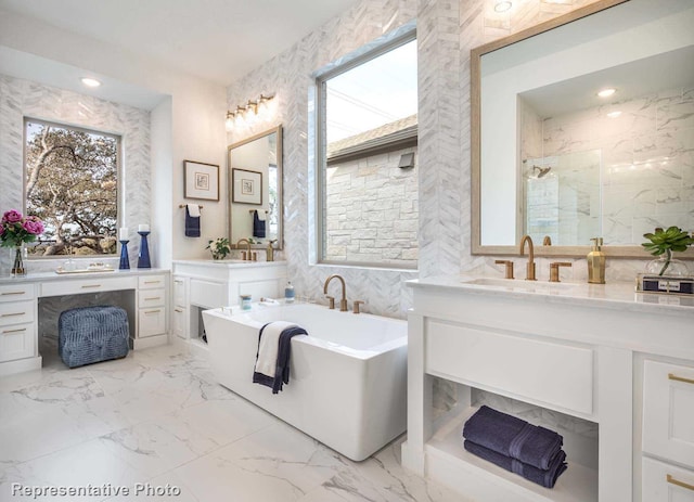 bathroom featuring vanity and independent shower and bath