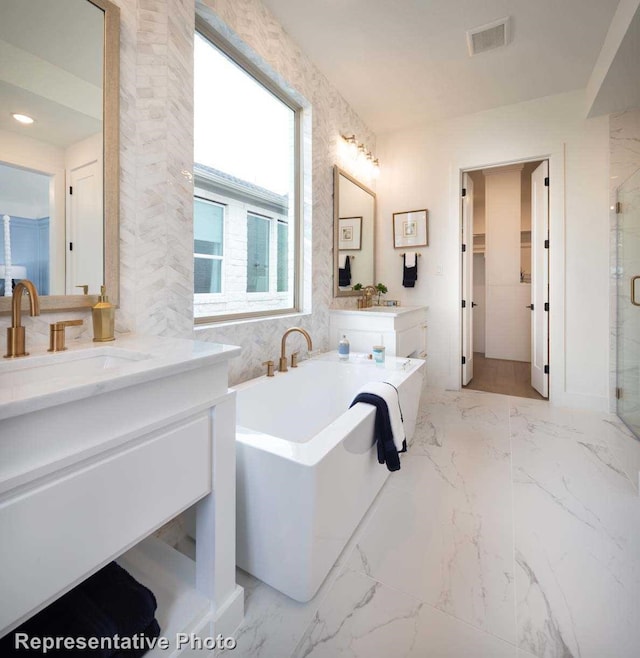 bathroom featuring plus walk in shower and vanity