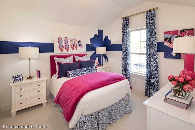 carpeted bedroom with lofted ceiling