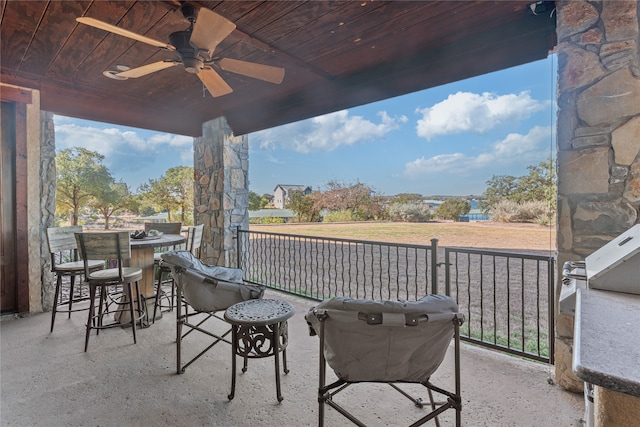 view of patio / terrace with ceiling fan and a balcony