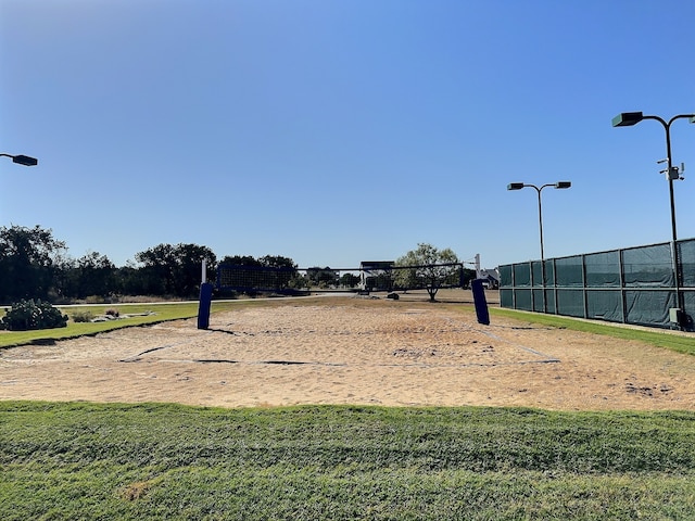 surrounding community featuring a yard and volleyball court