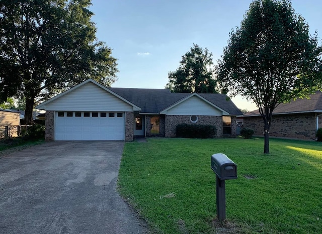 ranch-style home with a front yard and a garage