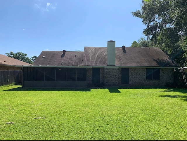 rear view of house with a yard