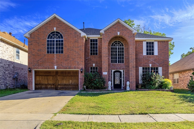 view of front of home featuring a front yard and a garage