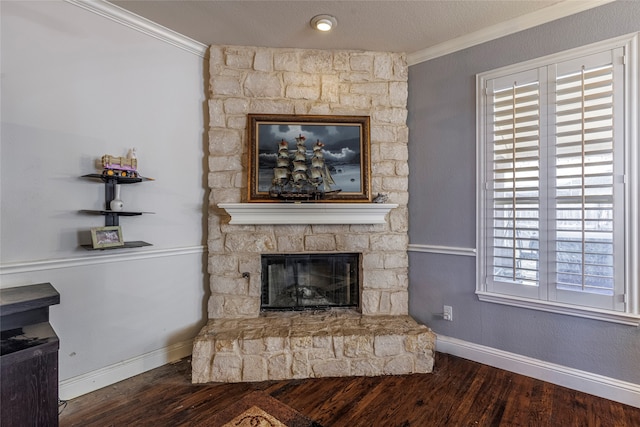 living room with a fireplace, wood-type flooring, a textured ceiling, and ornamental molding