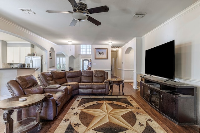 living room featuring ceiling fan, dark hardwood / wood-style flooring, and ornamental molding