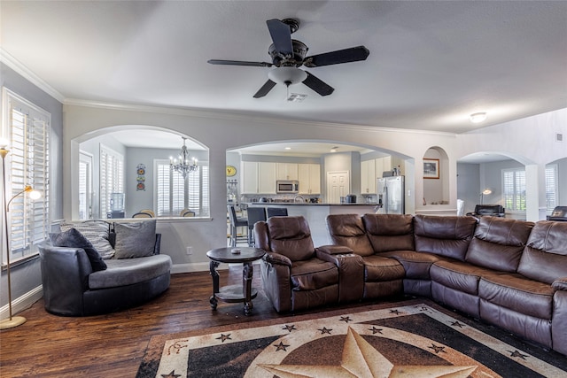 living room with ceiling fan with notable chandelier, dark hardwood / wood-style floors, plenty of natural light, and ornamental molding