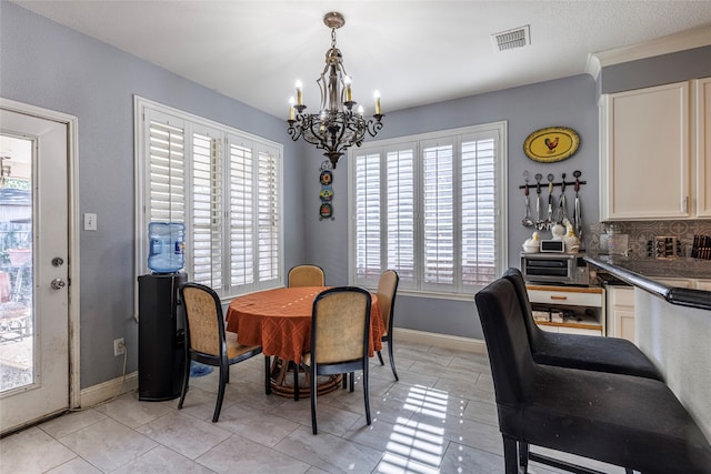 dining area featuring light tile patterned flooring and an inviting chandelier