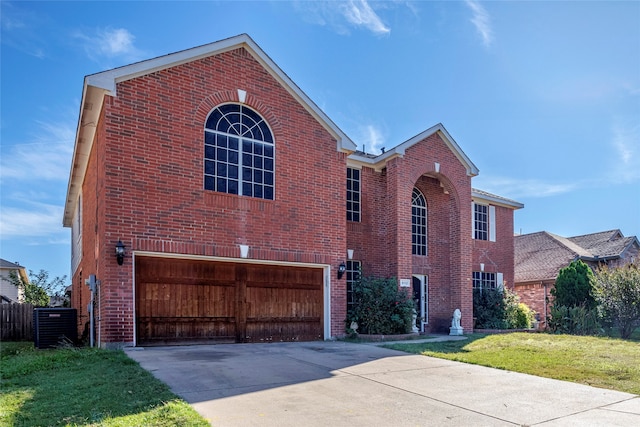 view of front of property with a garage, central air condition unit, and a front yard