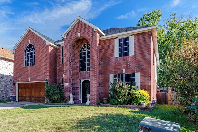 view of front of property with a front yard and a garage