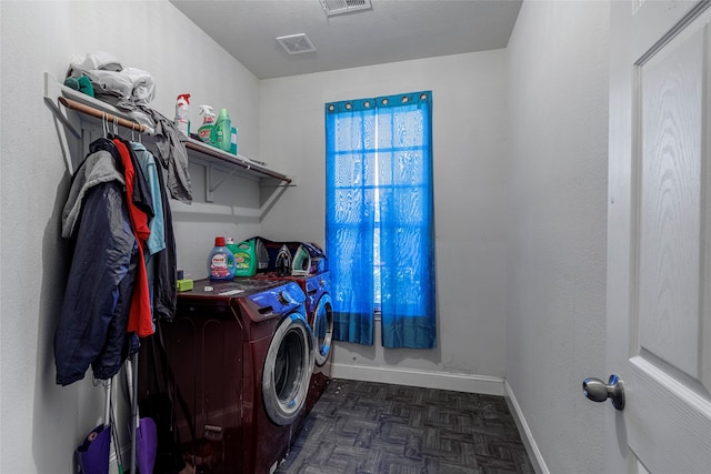 laundry room with dark parquet floors, a textured ceiling, and independent washer and dryer