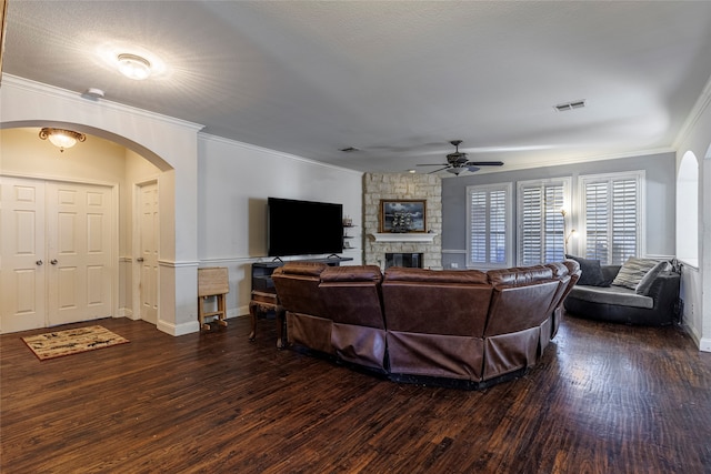 living room with dark hardwood / wood-style flooring, ceiling fan, and crown molding