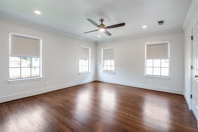 unfurnished room featuring a wealth of natural light, ornamental molding, and dark wood-type flooring