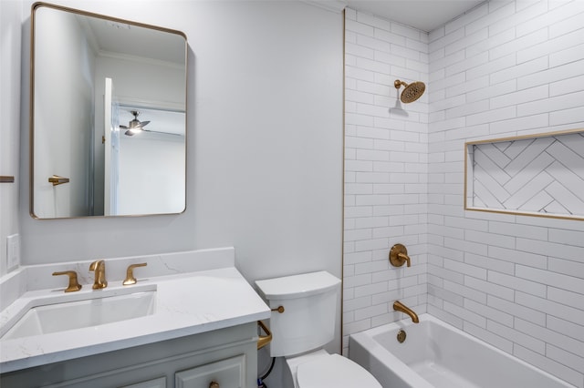 full bathroom featuring vanity, toilet, tiled shower / bath combo, and ornamental molding