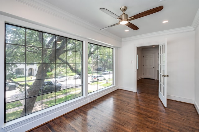 spare room featuring crown molding, ceiling fan, and dark hardwood / wood-style flooring