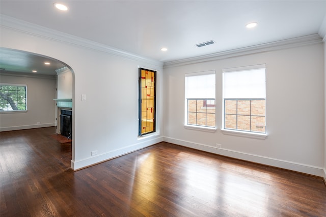 spare room featuring ornamental molding and dark wood-type flooring