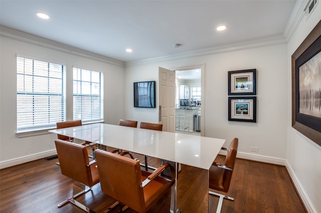 dining room with ornamental molding and dark hardwood / wood-style flooring