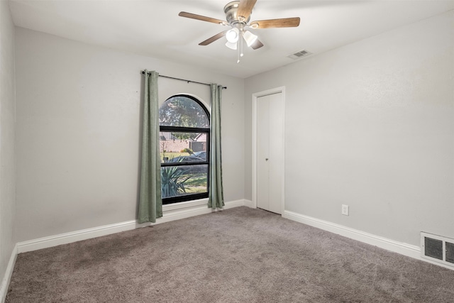 spare room featuring carpet flooring and ceiling fan