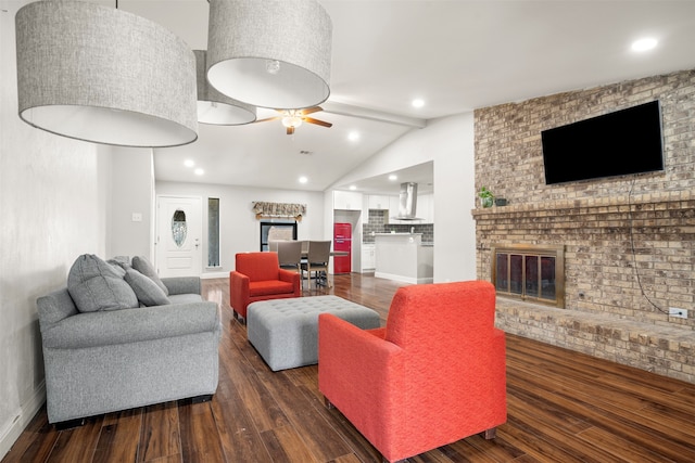 living room featuring lofted ceiling, dark wood-type flooring, a fireplace, and ceiling fan