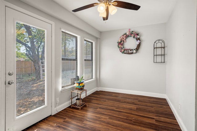 spare room featuring dark wood-type flooring and ceiling fan