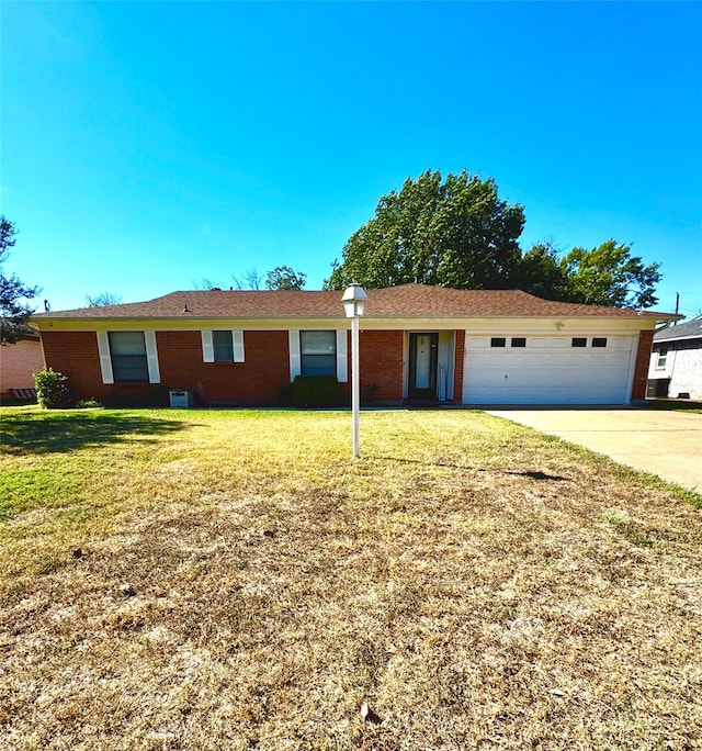 ranch-style home with a front yard and a garage