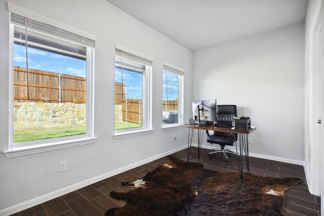 office with dark hardwood / wood-style floors and a wealth of natural light