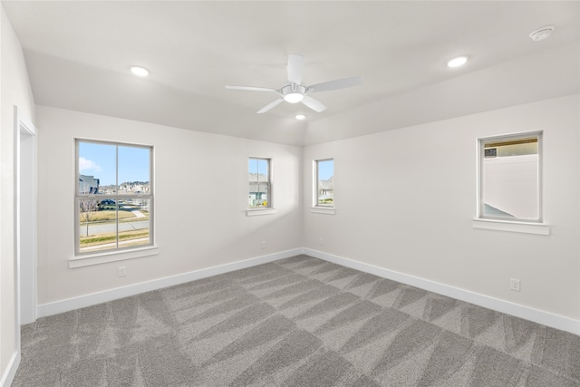 spare room featuring carpet floors, recessed lighting, ceiling fan, and baseboards