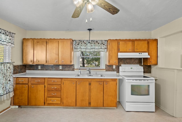 kitchen with hanging light fixtures, sink, electric range, and ceiling fan