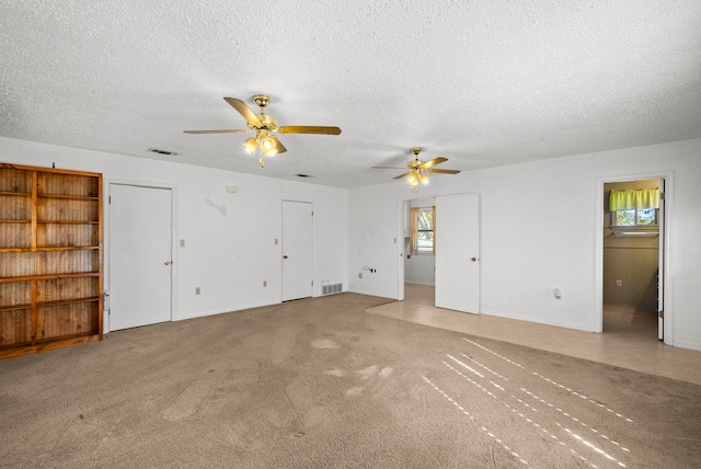 interior space featuring a textured ceiling and ceiling fan